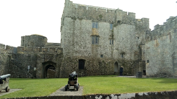 Vista de la torre principal del Castillo de Cahir, una fortaleza medieval en el condado de Tipperary, Irlanda, con sus imponentes murallas y el paisaje circundante.