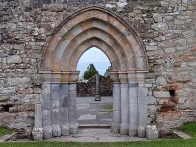 Ruins of the Clonmacnoise monastic complex, County Offaly, seen through an arch