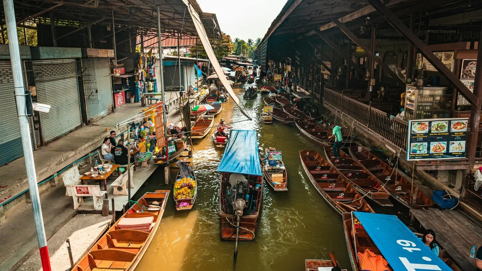 Bangkok floating market. Lots of traditional boats on the canal.